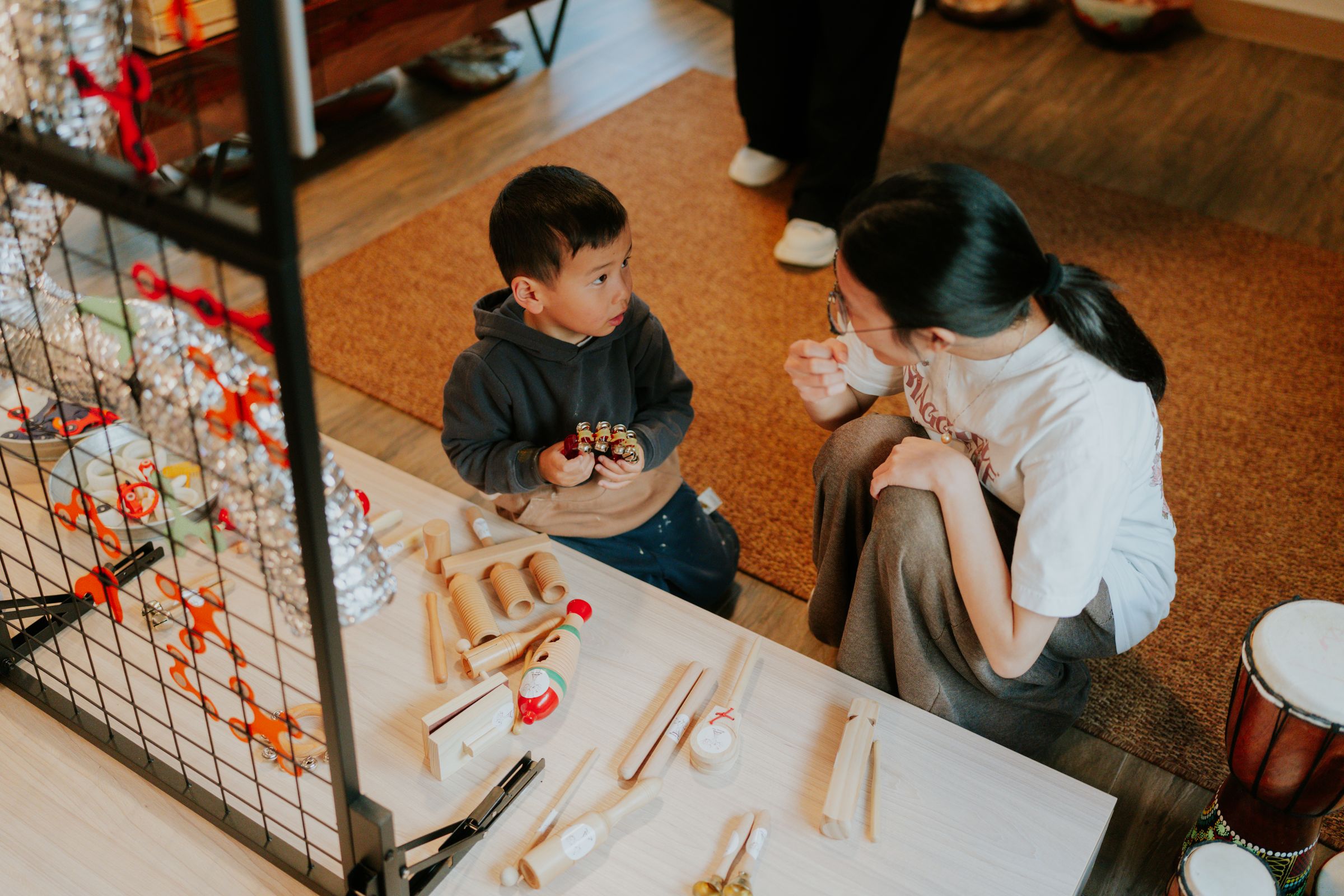 Children explore loose wooden parts with an educator